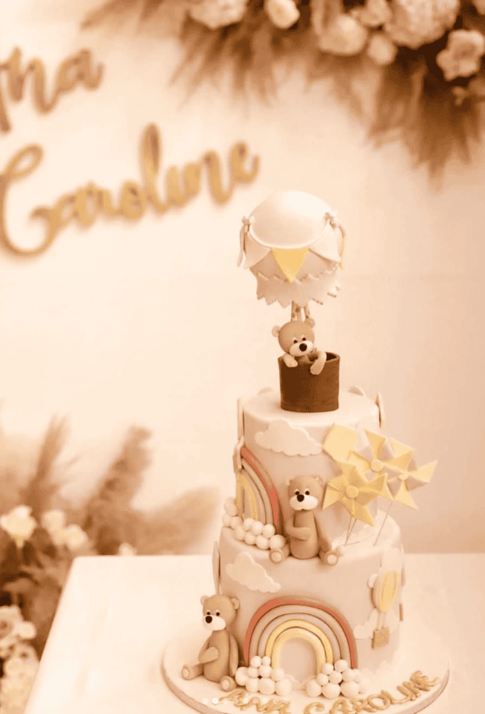 Cute bear-themed baby shower cake with rainbows, clouds, and windmills, perfect for a gender-neutral celebration.