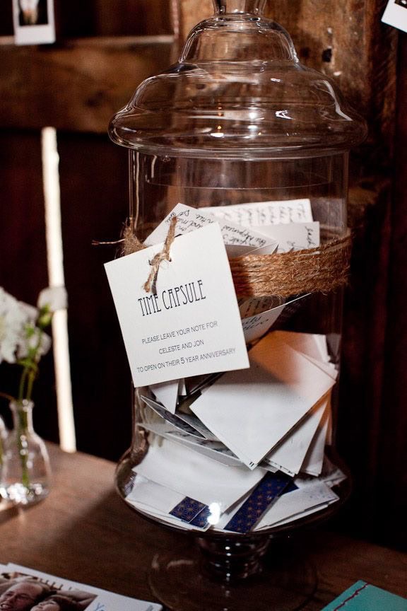 A glass jar filled with notes for a time capsule event.
