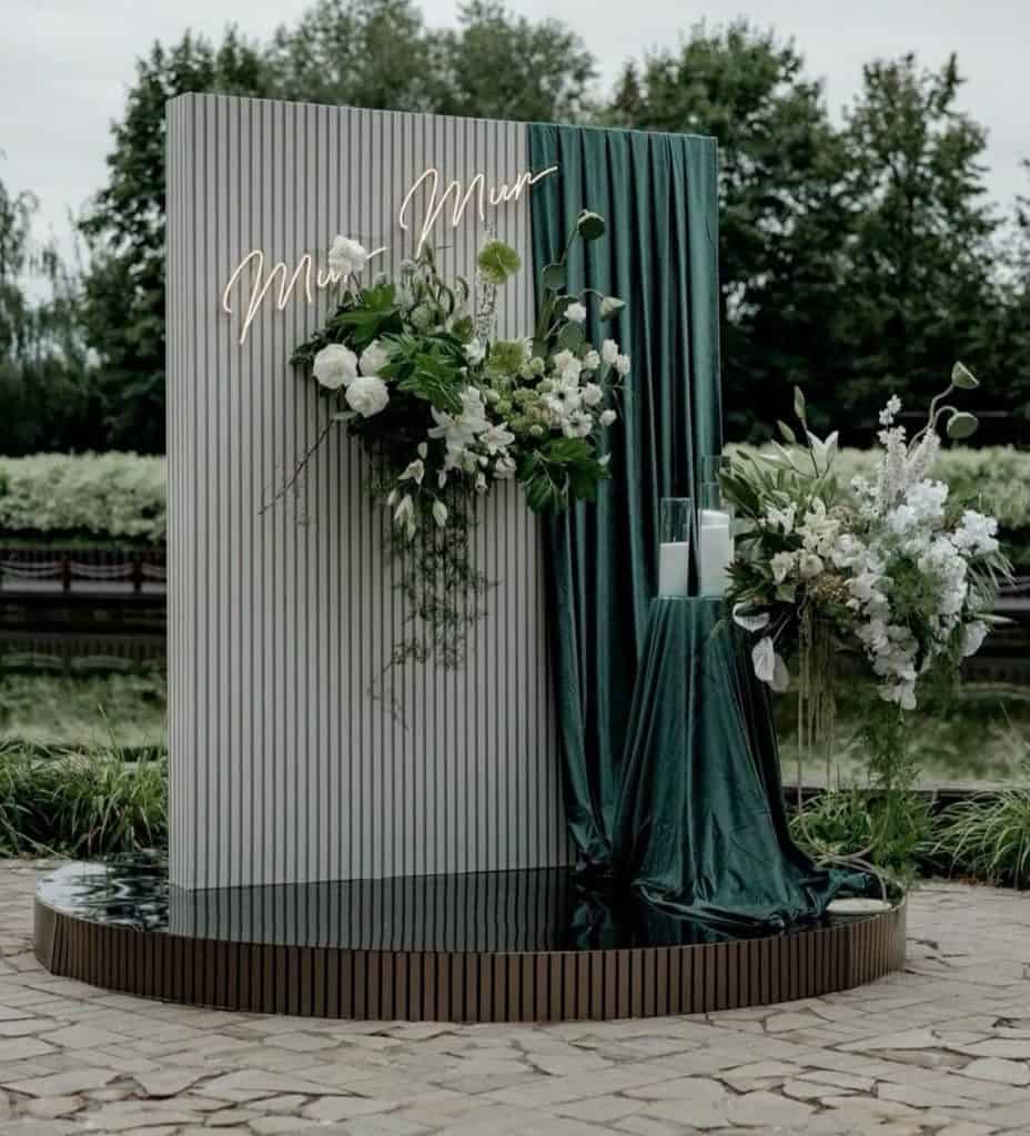 Elegant outdoor wedding or event decor featuring floral arrangements and modern design elements.