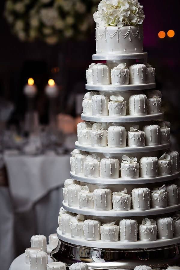 Elegant white wedding cake with intricate decoration for special event celebrations.