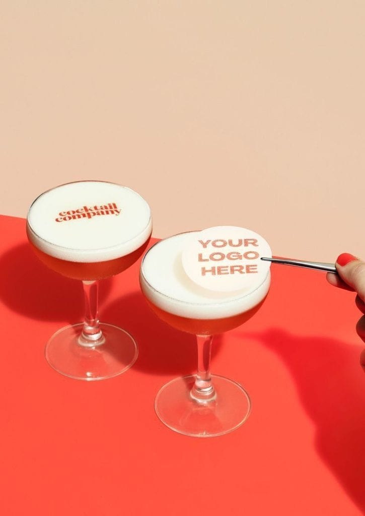 Elegant cocktail glasses with customizable foam logos for event branding and marketing.