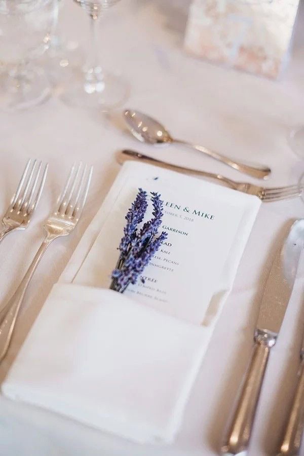 Lavender-themed wedding place setting with elegant cutlery and personalized menu card for upscale events.