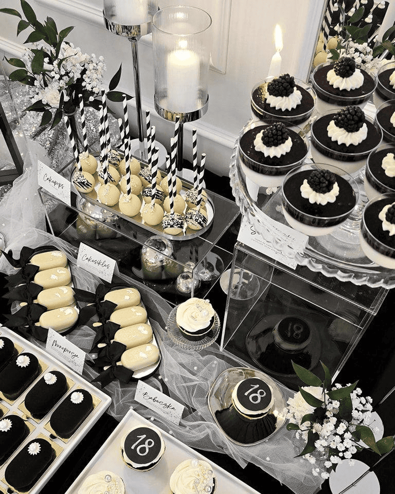 Elegant dessert table featuring black and white themed sweets for upscale events.