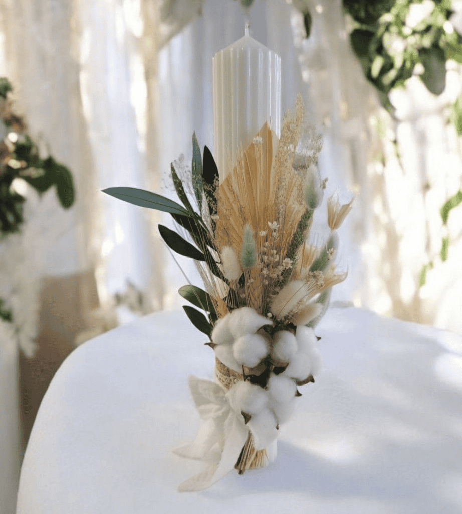 Elegant floral centerpiece with white cotton, dried flowers, and greenery for wedding and event decor.